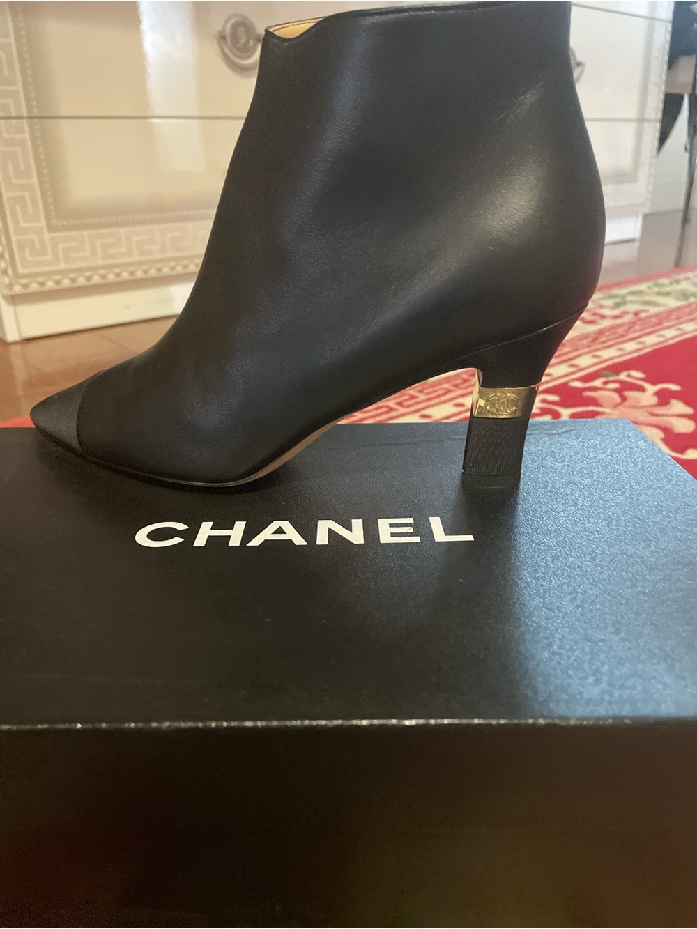 CHANEL Black Leather Ankle Booties with Gold Heel Band